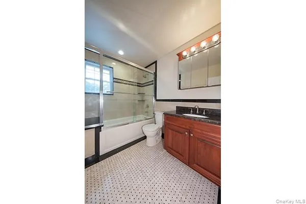 a bathroom with a sink a toilet and bathtub