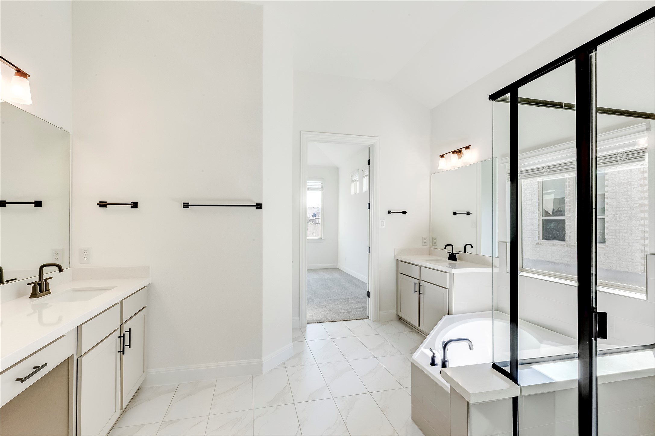 920 Old Gdn Road Leander, TX 78641 - Photo 20 of 39 Full bath featuring two vanities, a garden tub, and a stall shower