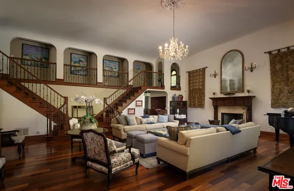 a living room with furniture fireplace and a large window
