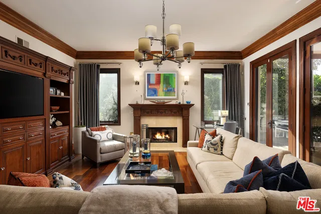 a living room with furniture fireplace and a large window