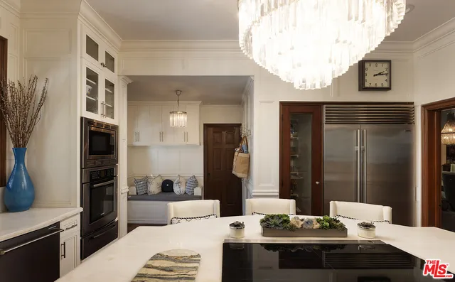 a dining room with furniture garden view and wooden floor