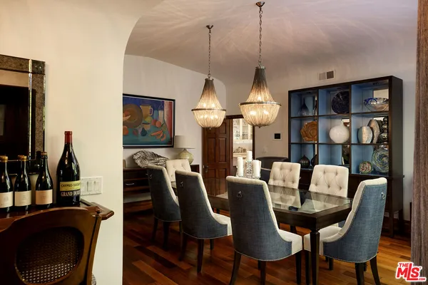 a view of a dining room with furniture and chandelier