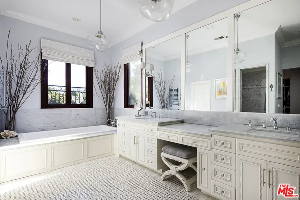a bedroom with a bed and a mirror