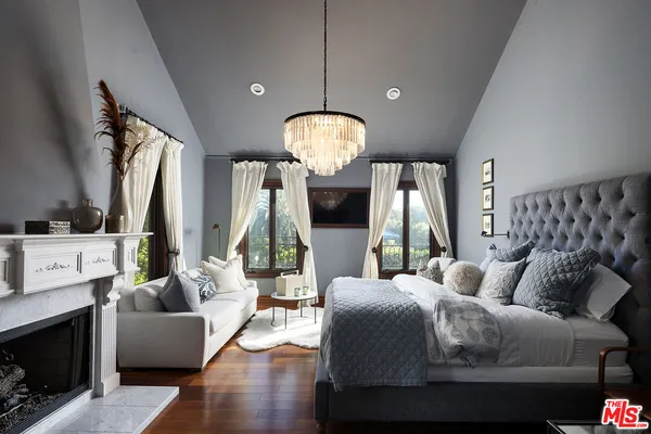 a living room with furniture and a floor to ceiling window