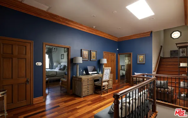 a bedroom with a large bed and a large window