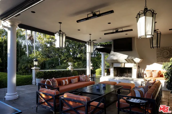 a view of a patio with table and chairs potted plants with palm trees