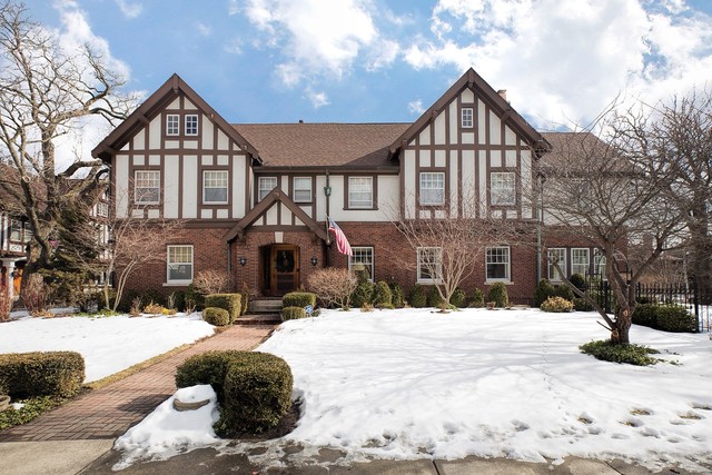 a front view of a house with snow on the road