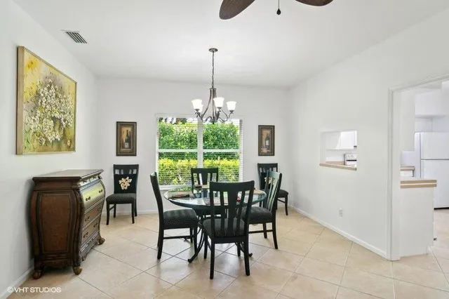 a dining room with furniture a chandelier and window