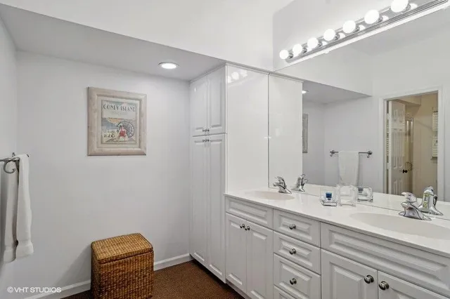 a bathroom with a sink a large mirror and a shower