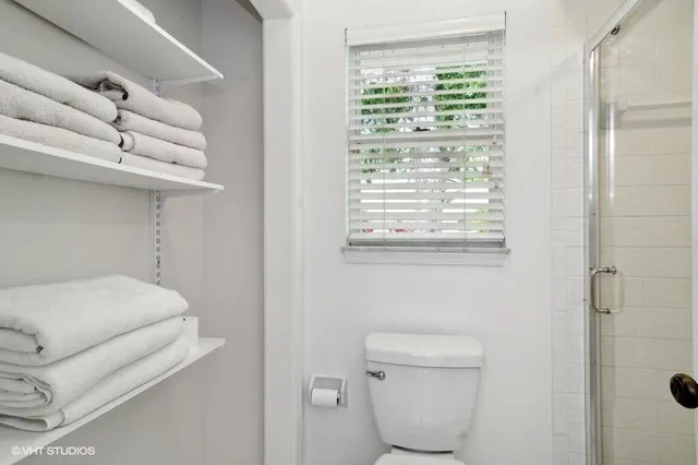 a bathroom with a toilet and a window