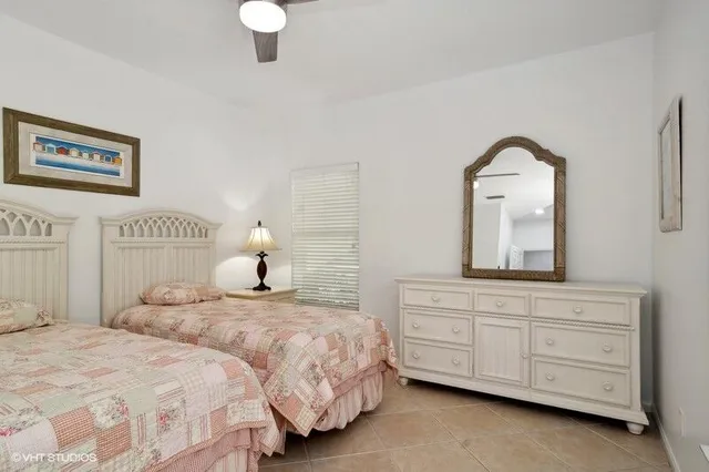 a bedroom with two beds and painting on the wall