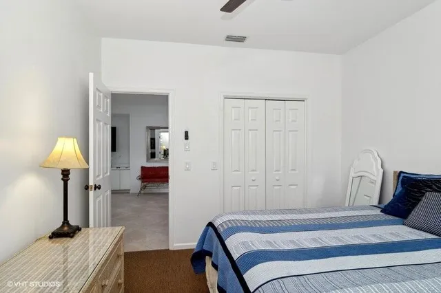 a bedroom with a bed and a lamp