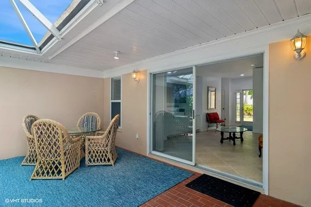 a view of a hallway with dining area and glass door