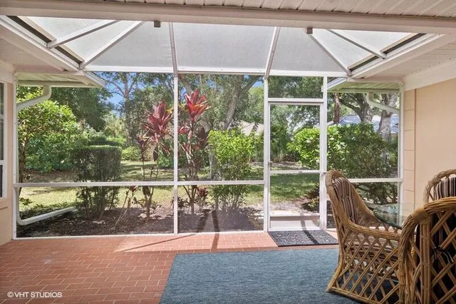 a view of a chair and tables in the patio