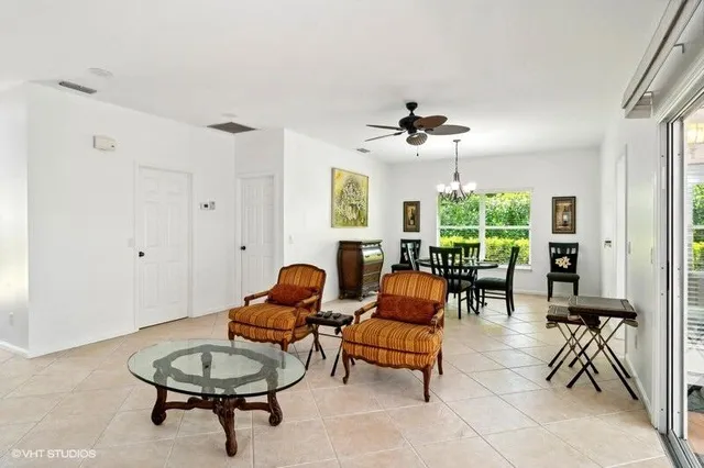 a living room with furniture a window and a chandelier