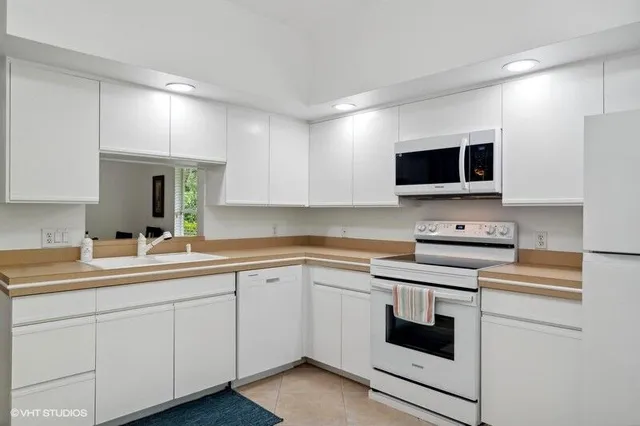 a kitchen with appliances cabinets and a sink