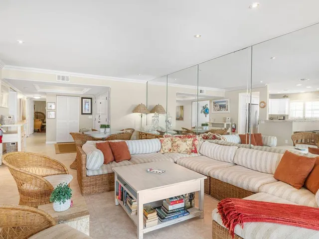 a view of a dining room with furniture and a chandelier