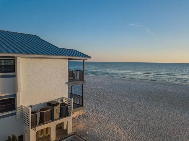 a bed sitting in a bedroom next to a large window