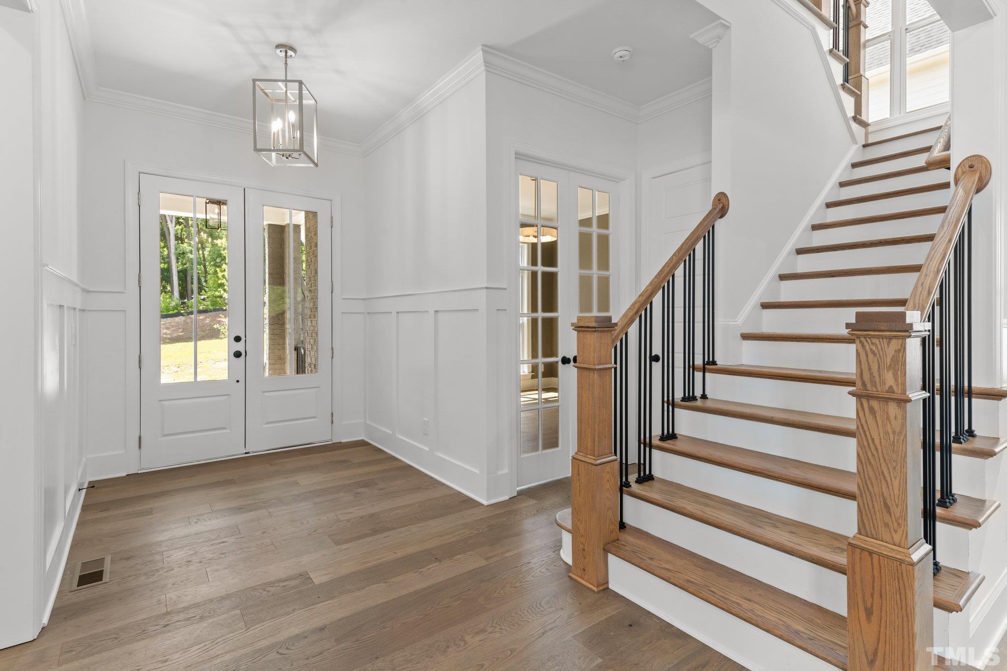9312 Field Maple Court Raleigh, NC 27613 - Photo 3 of 49 a view of entryway and hall with wooden floor
