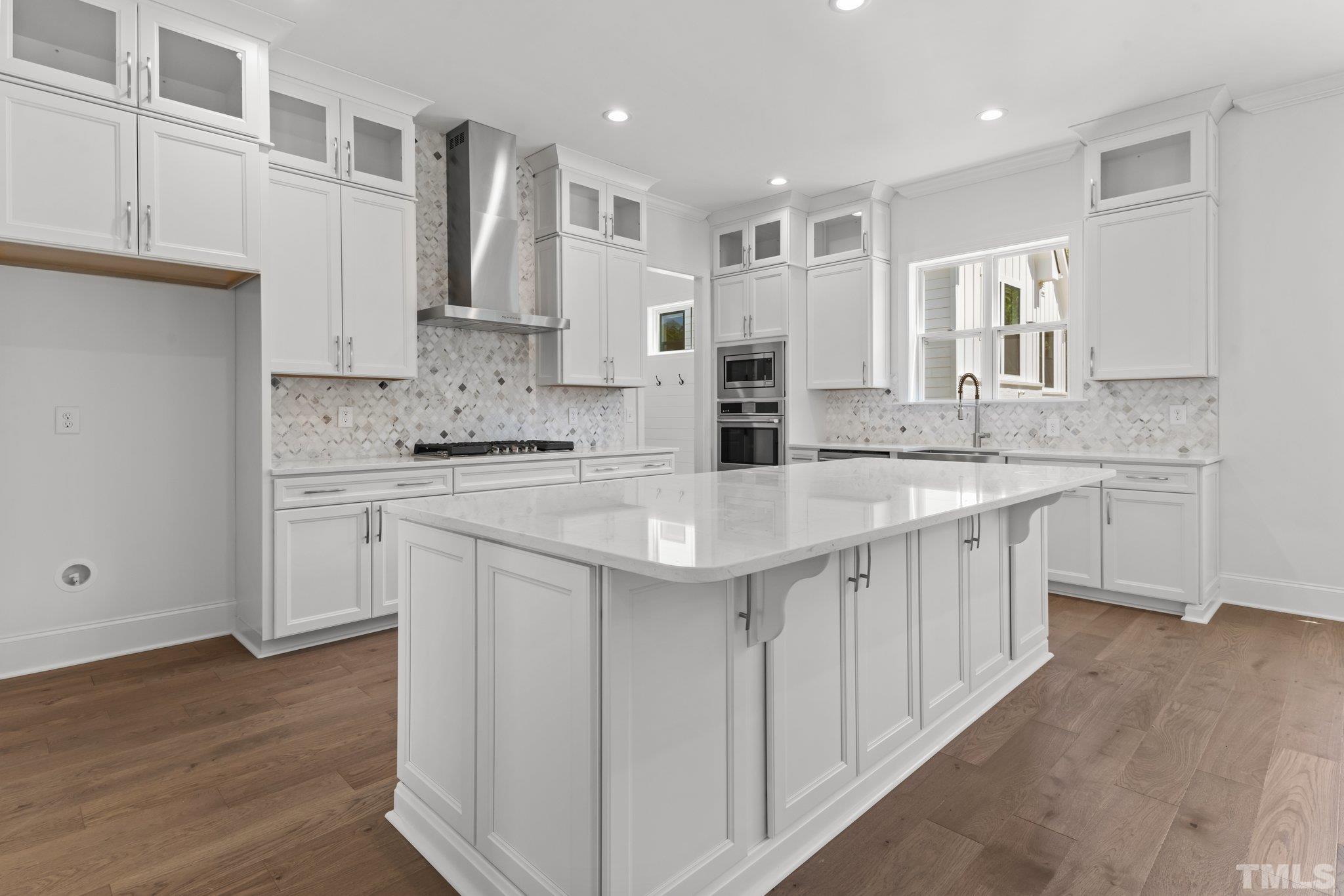 9312 Field Maple Court Raleigh, NC 27613 - Photo 10 of 49 a kitchen with stainless steel appliances kitchen island granite countertop a sink and cabinets