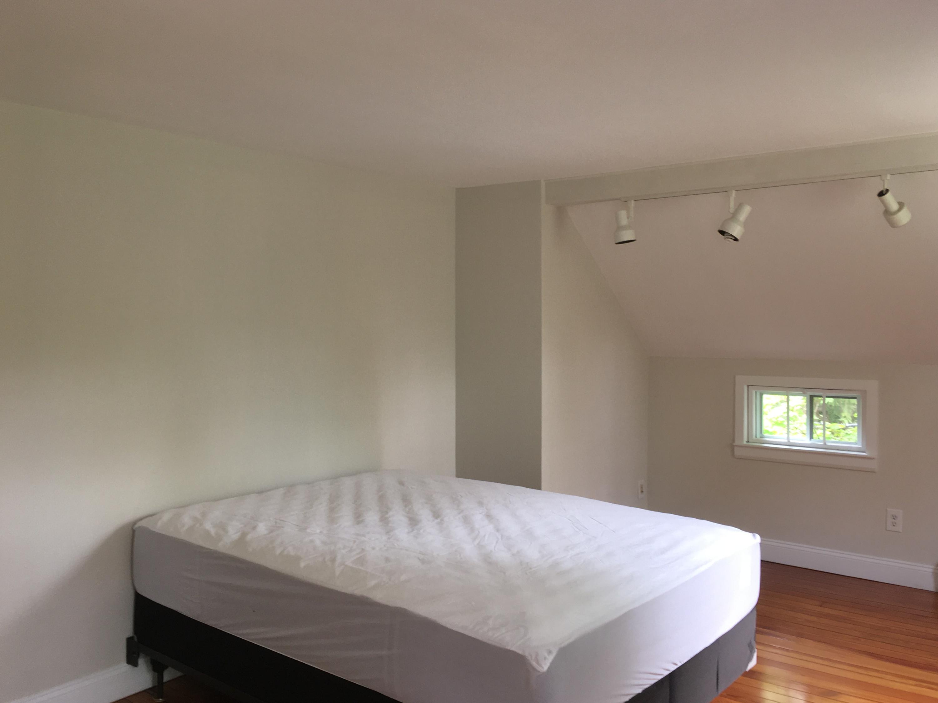 99 Main Street Sandwich, MA 02563 - Photo 12 of 17 a bed sitting in a bedroom next to a window