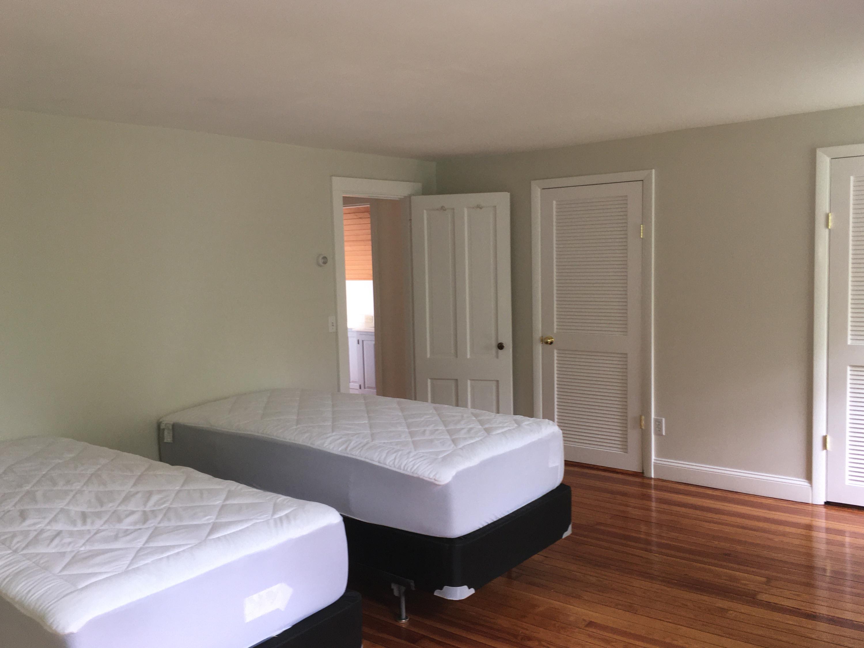 99 Main Street Sandwich, MA 02563 - Photo 14 of 17 a bedroom with a bed and a table