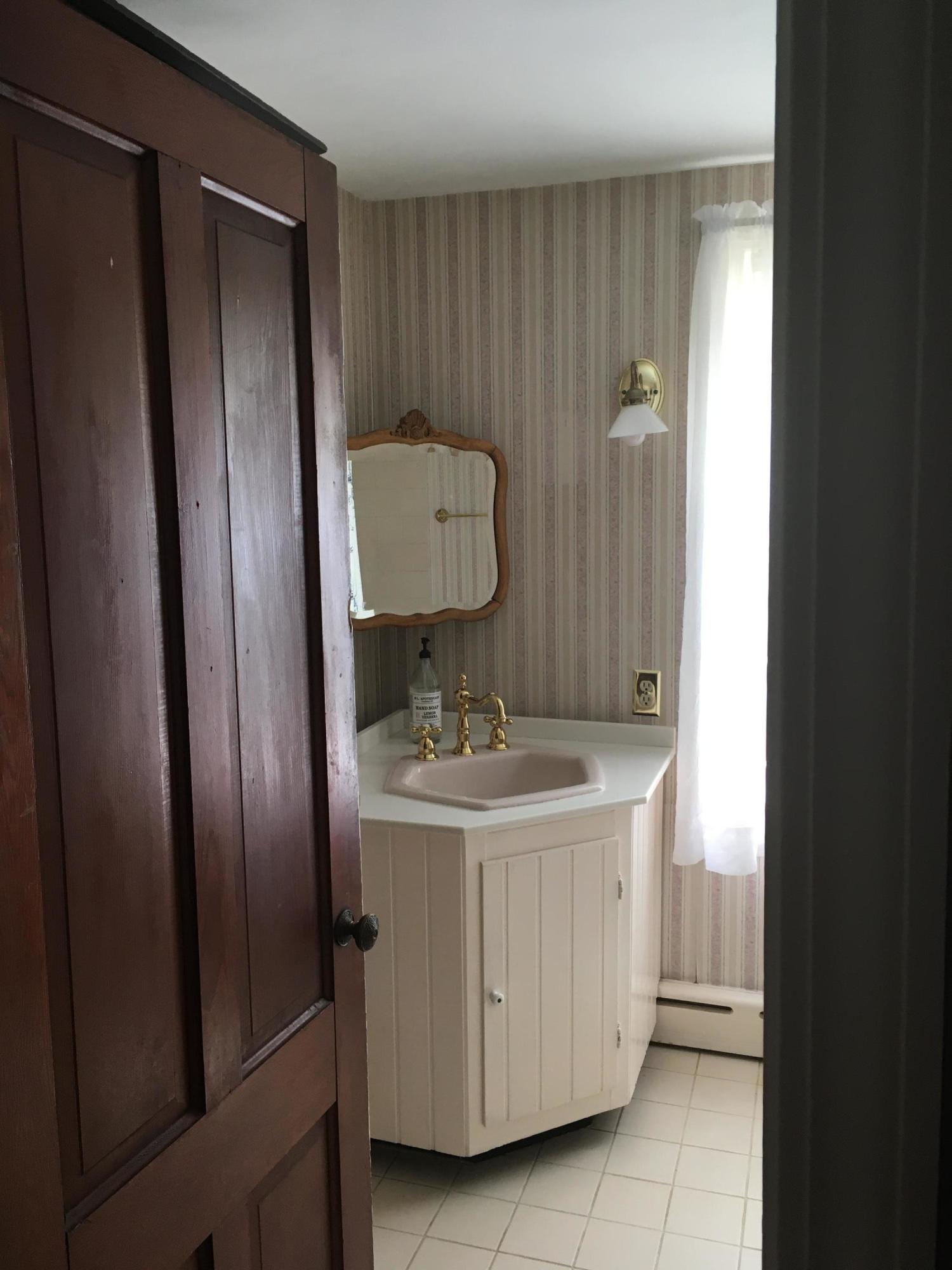 99 Main Street Sandwich, MA 02563 - Photo 7 of 17 a bathroom with a sink and a mirror