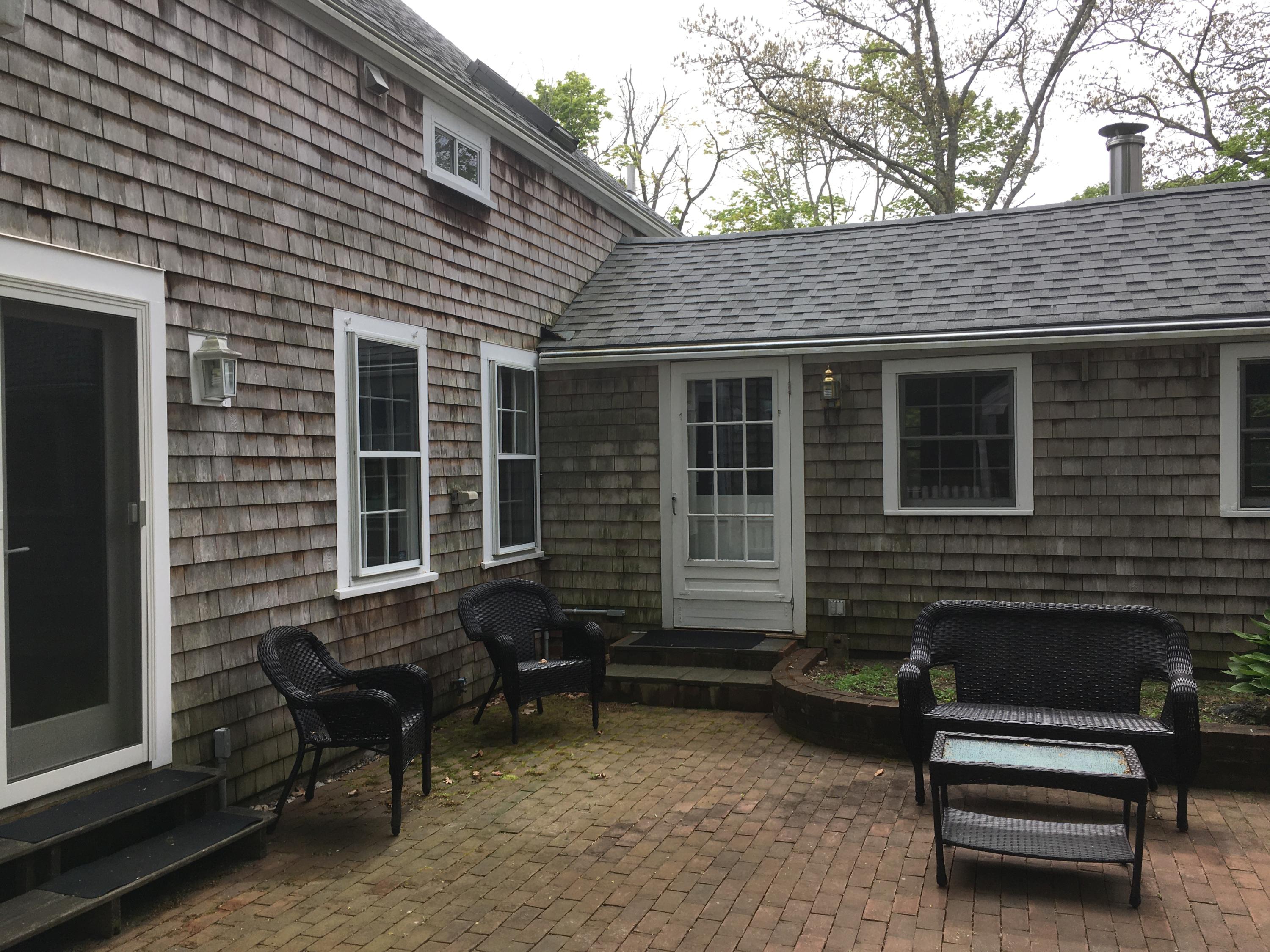 99 Main Street Sandwich, MA 02563 - Photo 8 of 17 a backyard of a house with outdoor seating