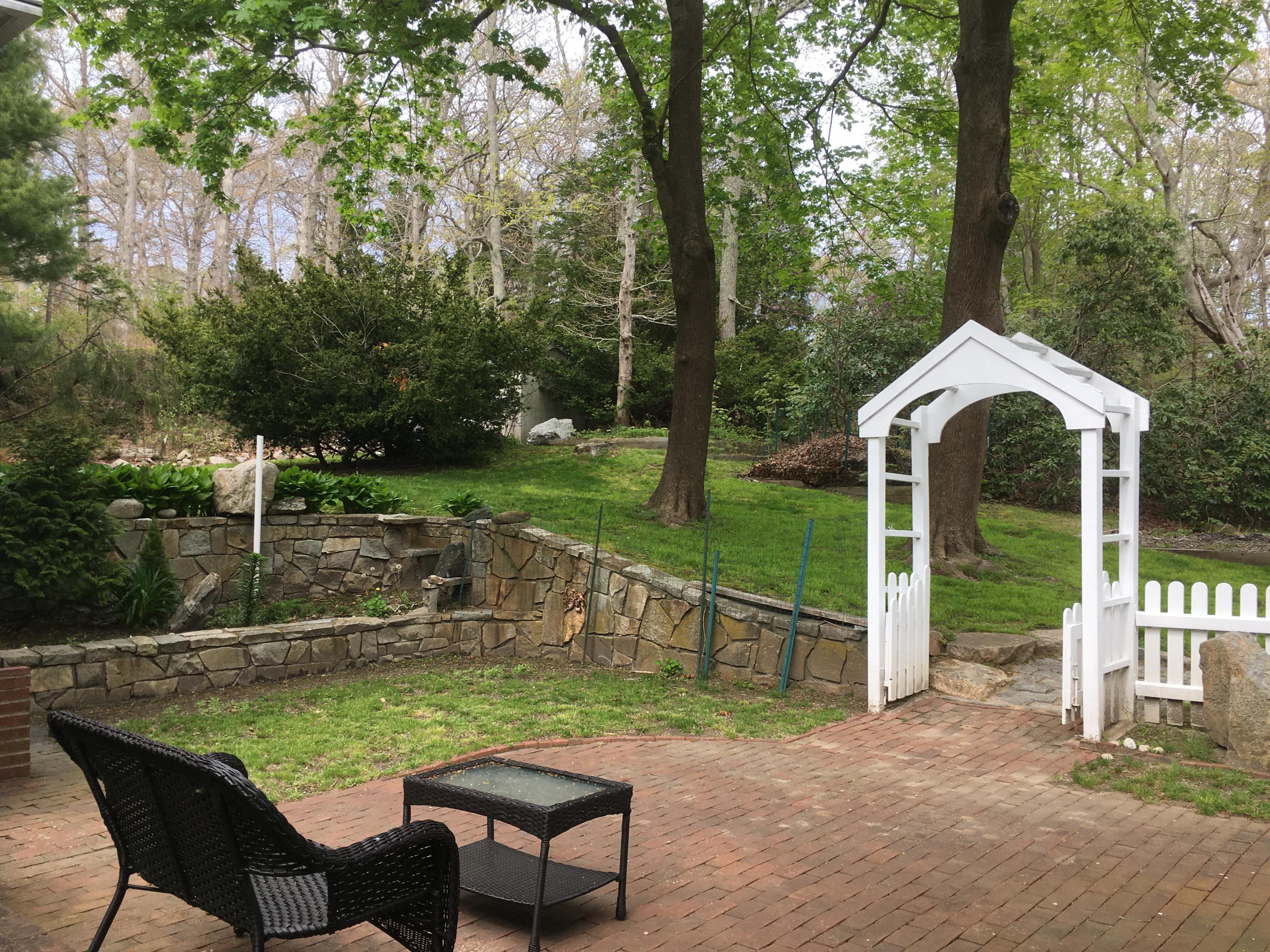 99 Main Street Sandwich, MA 02563 - Photo 9 of 17 a view of a house with backyard porch and sitting area