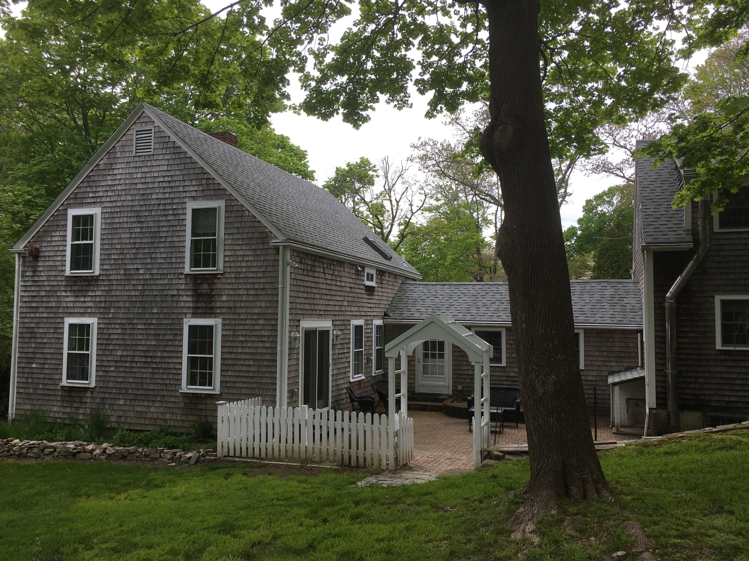 99 Main Street Sandwich, MA 02563 - Photo 10 of 17 a view of a house with a yard and a large tree