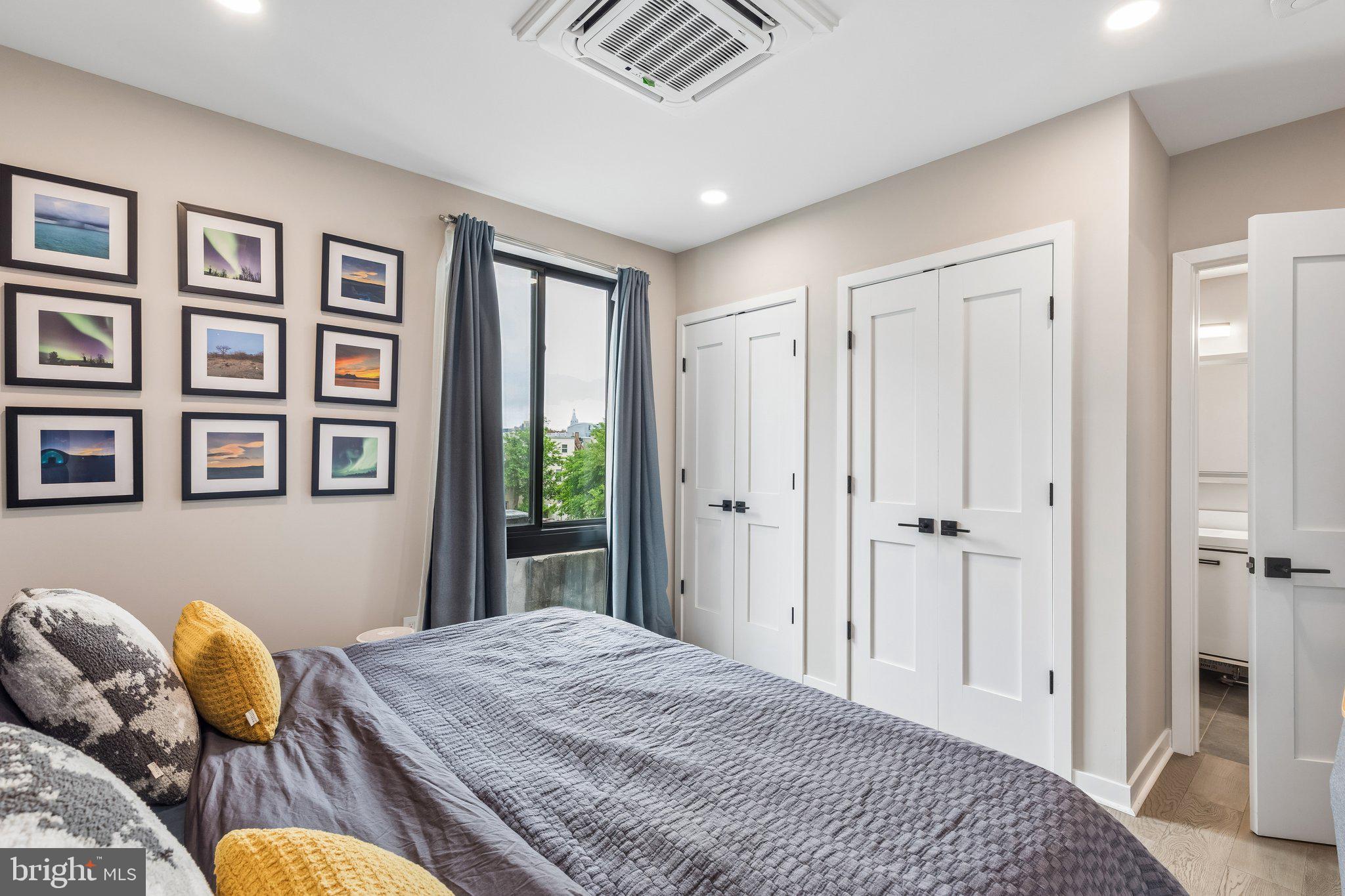 1648-50 Ridge Avenue, Unit 302 Philadelphia, PA 19130 - Photo 19 of 38 a bedroom with a bed and wooden floor