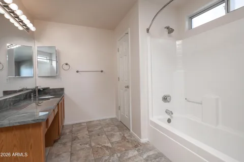 a spacious bathroom with a granite countertop sink a toilet and shower