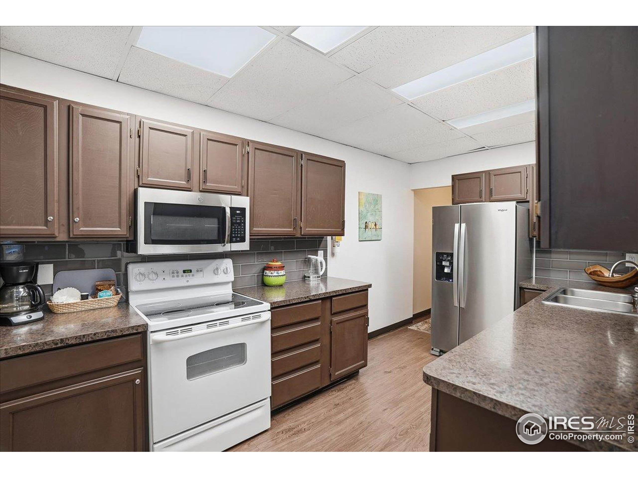 415 South Howes Street, Unit N206 Fort Collins, CO 80521 - Photo 36 of 48 a kitchen with stainless steel appliances granite countertop a refrigerator stove top oven a sink and dishwasher