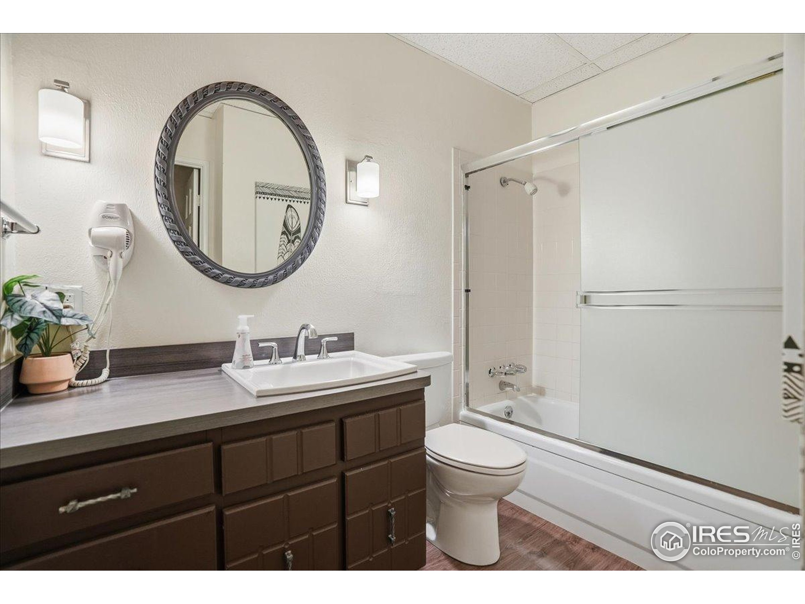 415 South Howes Street, Unit N206 Fort Collins, CO 80521 - Photo 37 of 48 a bathroom with a granite countertop toilet a sink and a mirror