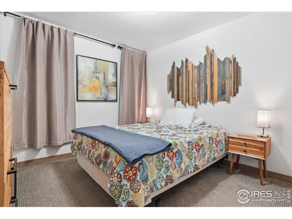 a bedroom with two beds and painting on the wall