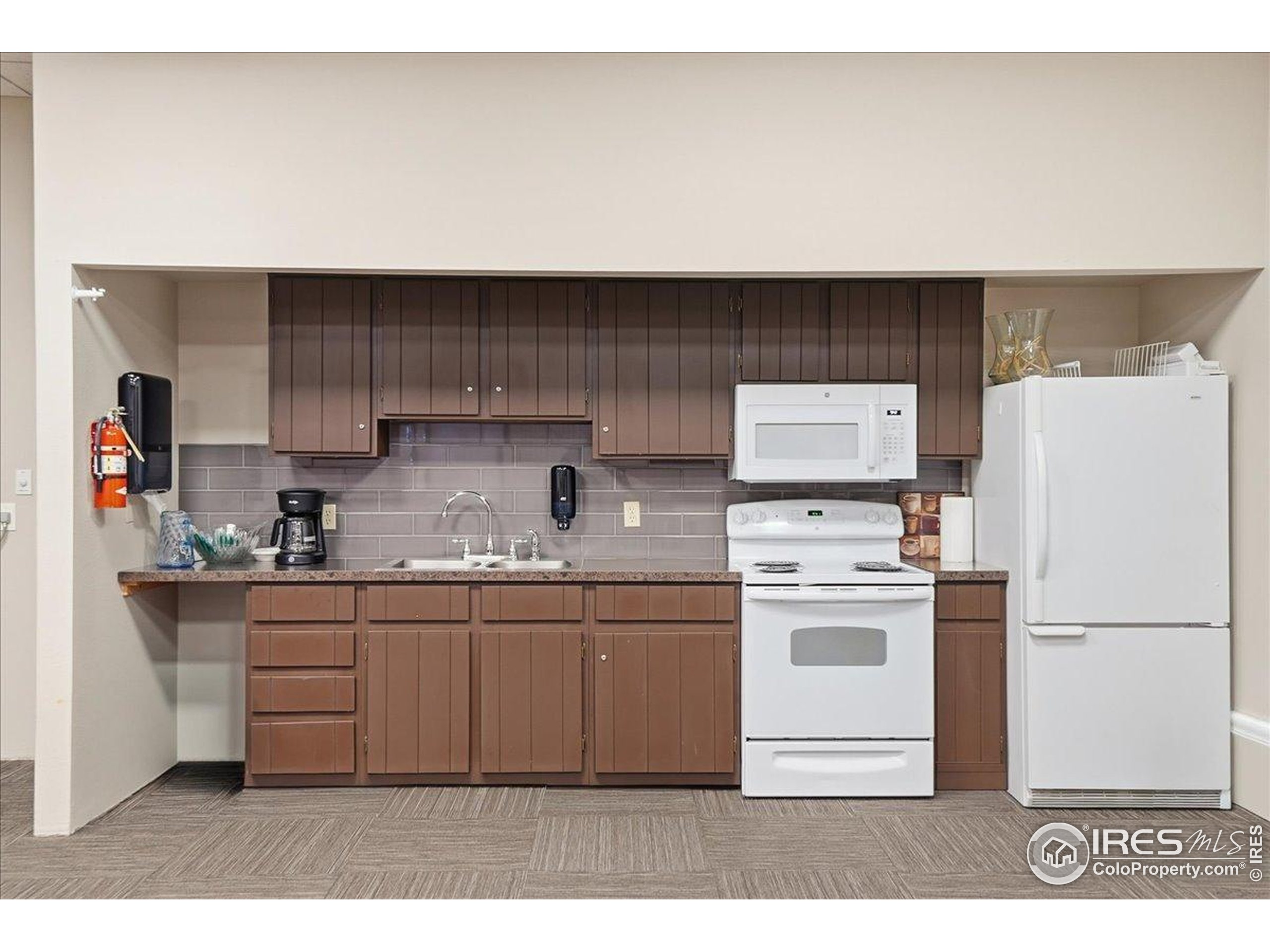 415 South Howes Street, Unit N206 Fort Collins, CO 80521 - Photo 45 of 48 a kitchen with stainless steel appliances a stove a refrigerator and cabinets