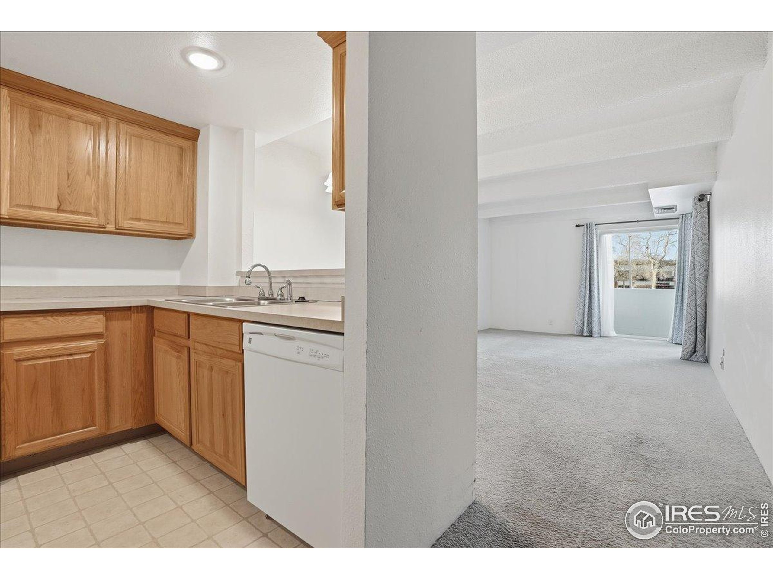 415 South Howes Street, Unit N206 Fort Collins, CO 80521 - Photo 6 of 48 a kitchen with cabinets and wooden floor