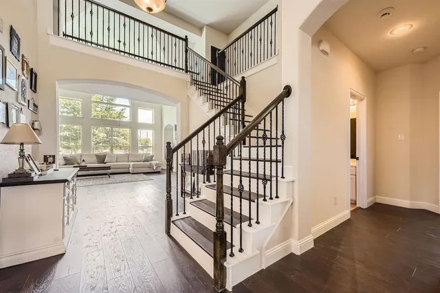 a view of staircase with lots of frames and a wooden floor