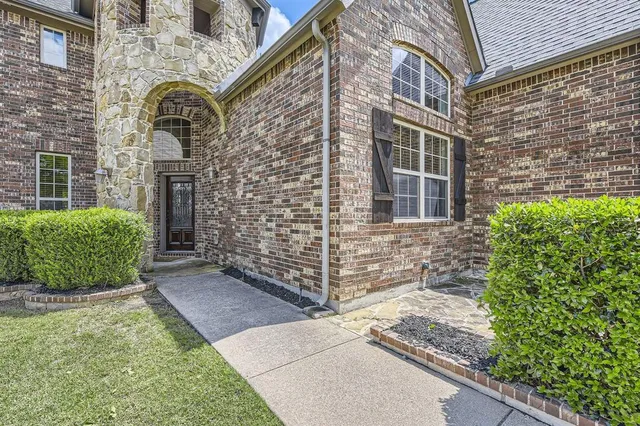 a view of a brick house with a large windows