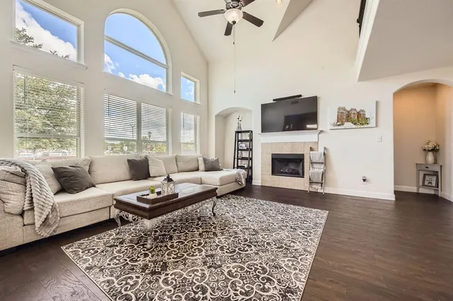 a living room with furniture a flat screen tv and a fireplace
