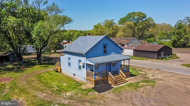 an aerial view of a house with swimming pool and sitting area
