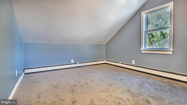 a white building with a granite countertop shower and a sink