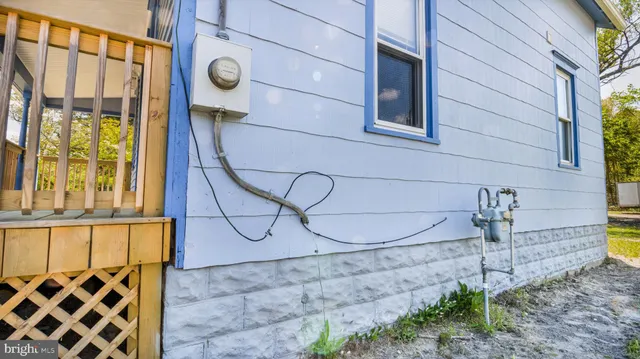 a white house that has a tree in front of it