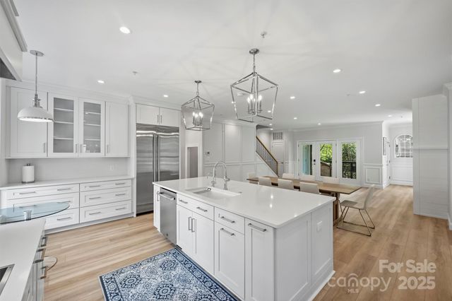 a large white kitchen with a large window