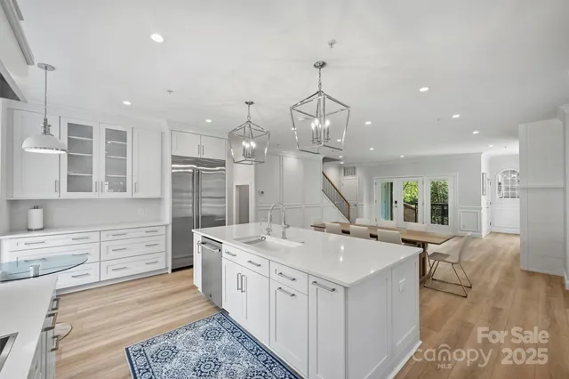 a large white kitchen with a large window