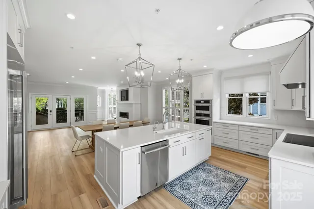 a large white kitchen with a large window