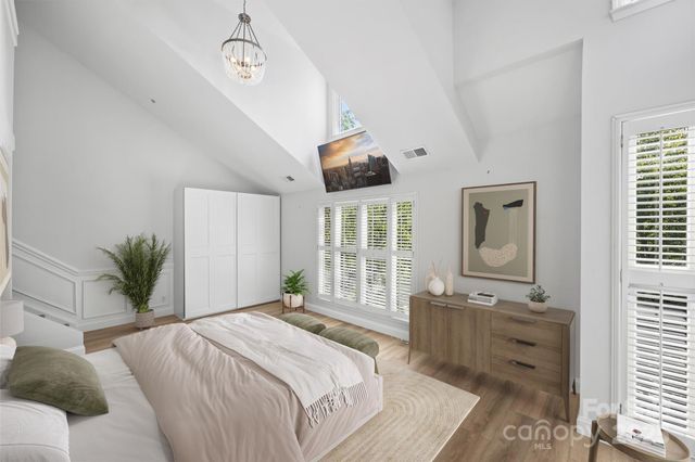 a bedroom with a large bed and a window