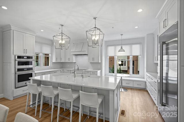 a kitchen with stainless steel appliances granite countertop a stove and a refrigerator