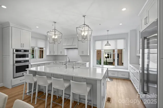 a kitchen with stainless steel appliances granite countertop a stove and a refrigerator