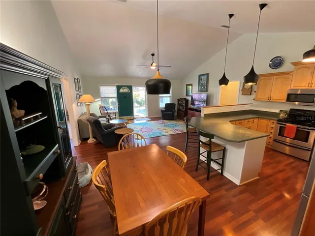 a kitchen with stainless steel appliances granite countertop a stove a sink and a refrigerator